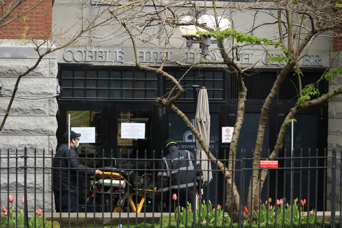 Emergency Medical Service workers unload a patient out of their ambulance at the Cobble Hill Health Center in New York City, N.Y. on April 18, 2020. (Justin Heiman/Getty Images)