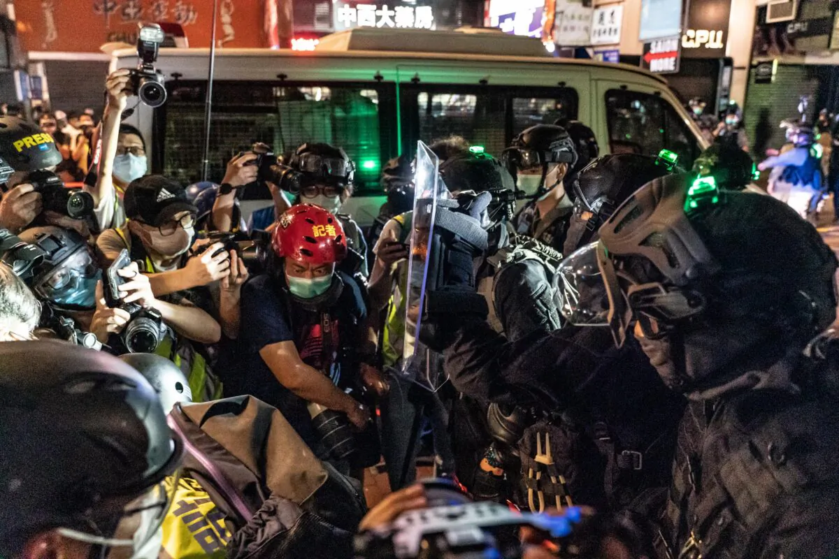 Riot police hold back members of the media during a demonstration in Mongkok district in Hong Kong, on May 10, 2020. (Anthony Kwan/Getty Images)