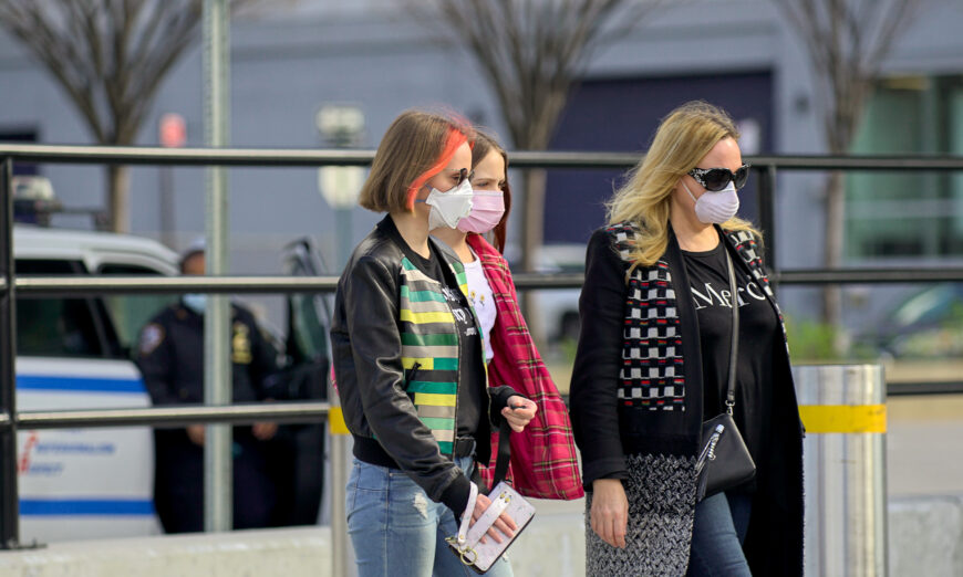 People wear masks as they walk on the street in New York City, on April 4, 2020. (Chung I Ho/The Epoch Times)