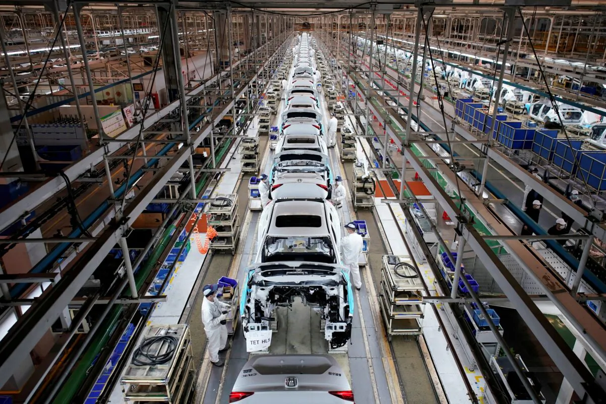 Employees work on a production line inside a Dongfeng Honda factory after lockdown measures in Wuhan, the capital of Hubei province and China's epicentre of the CCP virus outbreak, were further eased, on April 8, 2020. (Aly Song/REUTERS)