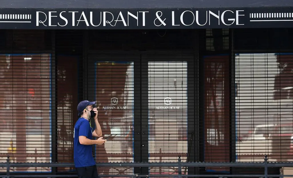 A pedestrian walks past a closed Artisan House restaurant in Los Angeles on May 7, 2020. (Frederic J. Brown/AFP via Getty Images)