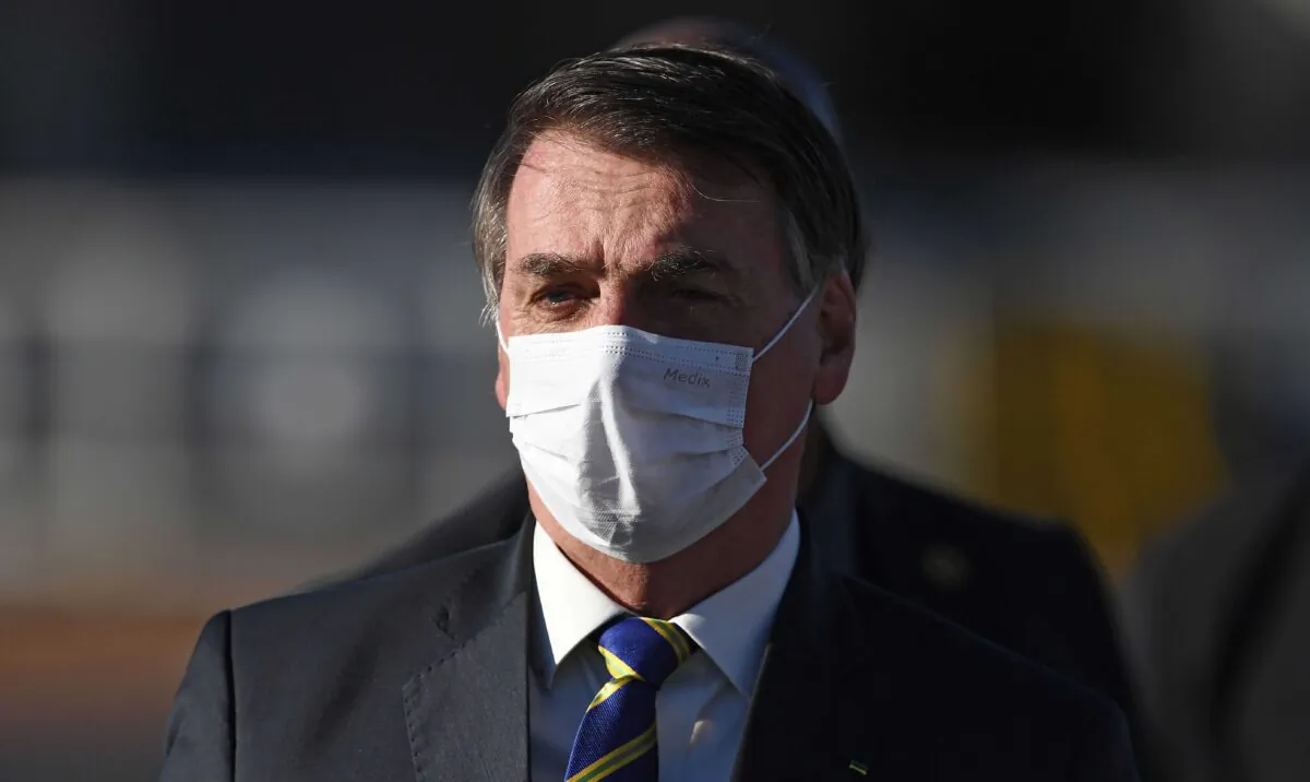 Brazilian President Jair Bolsonaro arrives at the flag-raising ceremony before a ministerial meeting at the Alvorada Palace in Brasilia, on May 12, 2020. (Evaristo Sa/AFP via Getty Images)