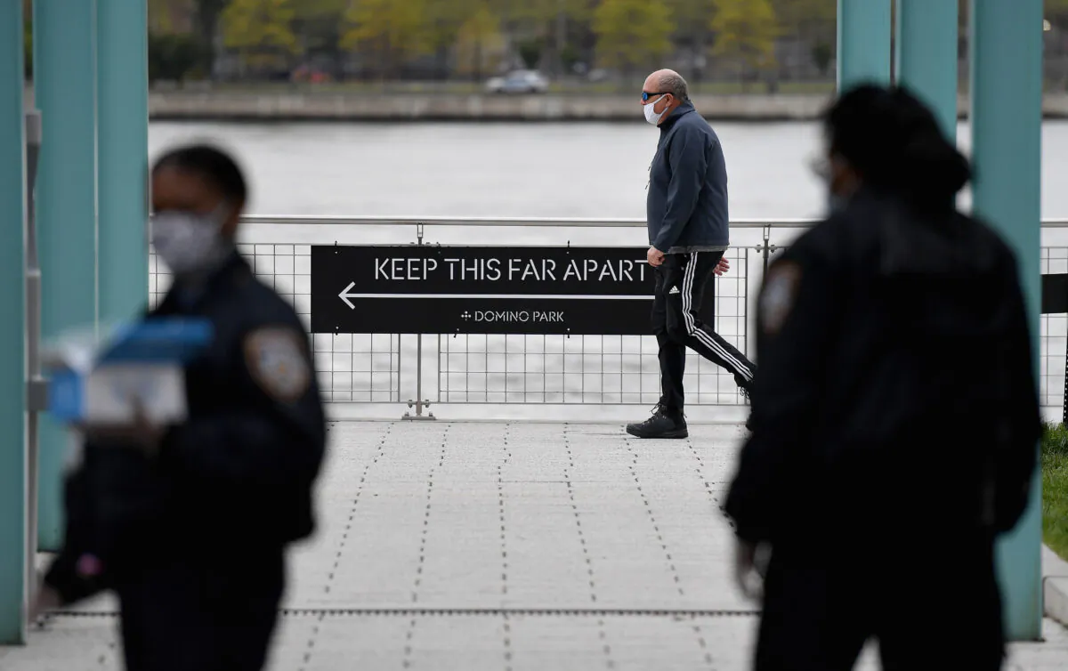 NYPD officers hand out free protective masks in the Brooklyn borough of New York City, on May 11, 2020. (Angela Weiss/AFP via Getty Images)