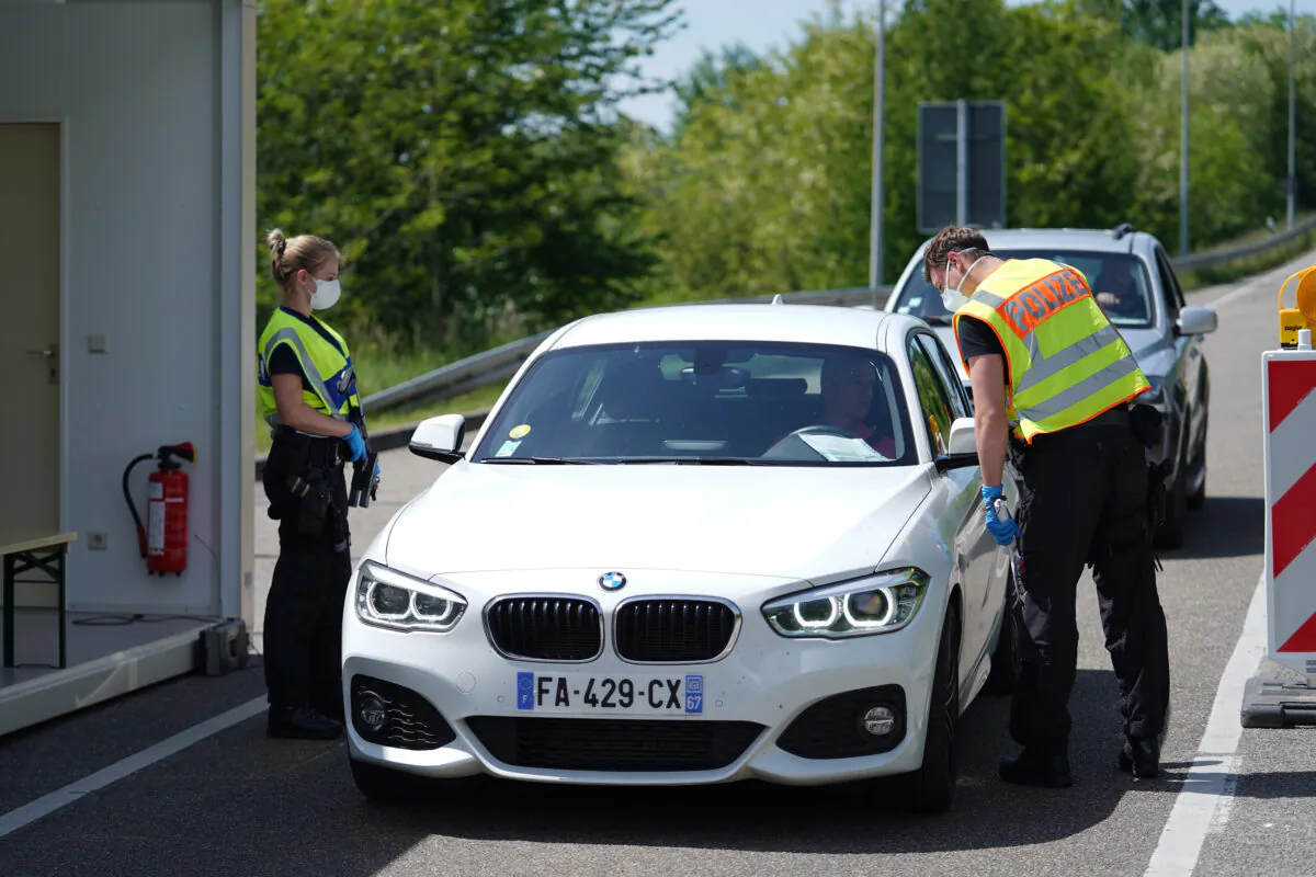 German border police officers stop cars in a checkpoint of the D87 road at the German-French border during the CCP virus crisis near Rastatt, Germany, on May 8, 2020.  (Thomas Niedermueller/Getty Images)