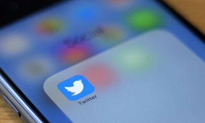 The Twitter logo is seen on a phone in this photo illustration in Washington, on July 10, 2019. (Alastair Pike/AFP via Getty Images)
