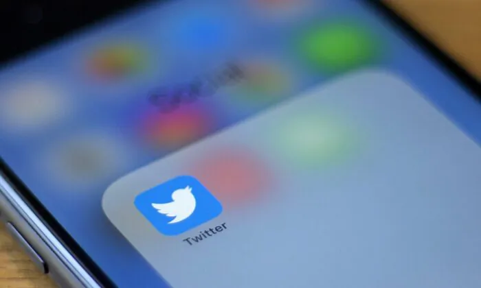 The Twitter logo is seen on a phone in this photo illustration in Washington, on July 10, 2019. (Alastair Pike/AFP/Getty Images)