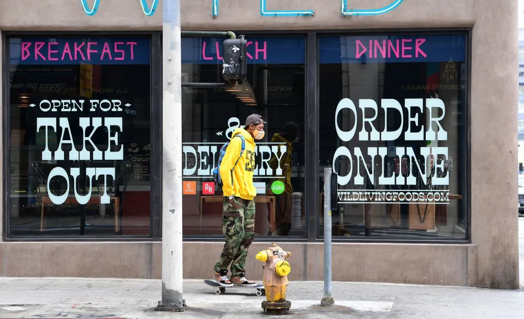 Chairs remain stacked on tables at a restaurant open for takeout in Los Angeles on May 12, 2020. California Governor Gavin Newsom announced guidelines for reopening dine-in restaurants with self-distancing and cleanliness procedures during the pandemic. (Photo by FREDERIC J. BROWN/AFP via Getty Images)