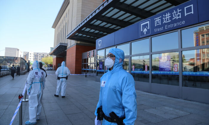 Police officers stand guard outside Jilin city's railway station which is closed due to the CCP virus outbreak in Jilin, China on May 13, 2020. (STR/AFP via Getty Images)
