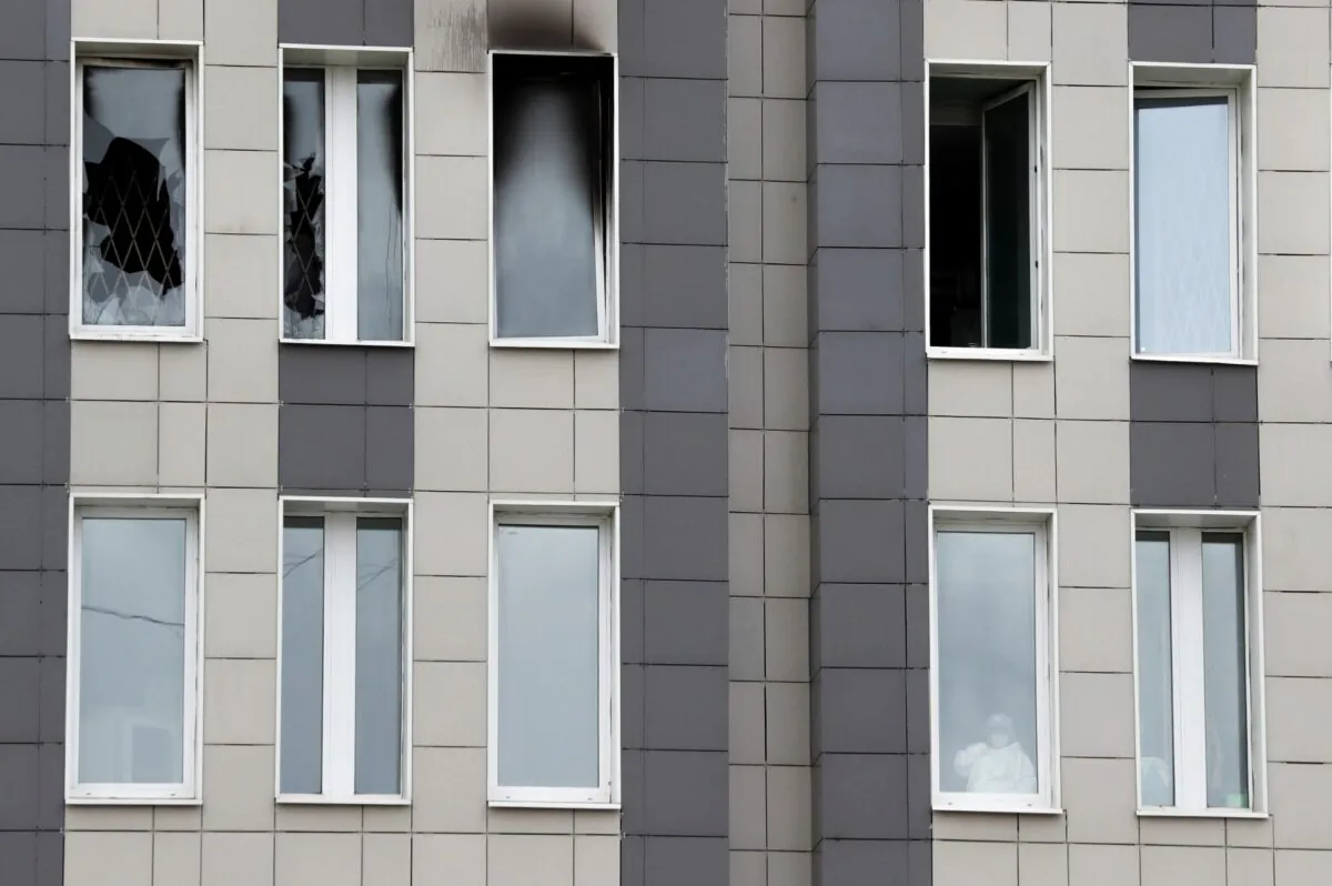A medical specialist is seen in a window after a fire, which killed five CCP virus patients in an intensive care unit, at a hospital in St. Petersburg, Russia, on May 12, 2020. (Anton Vaganov/Reuters)