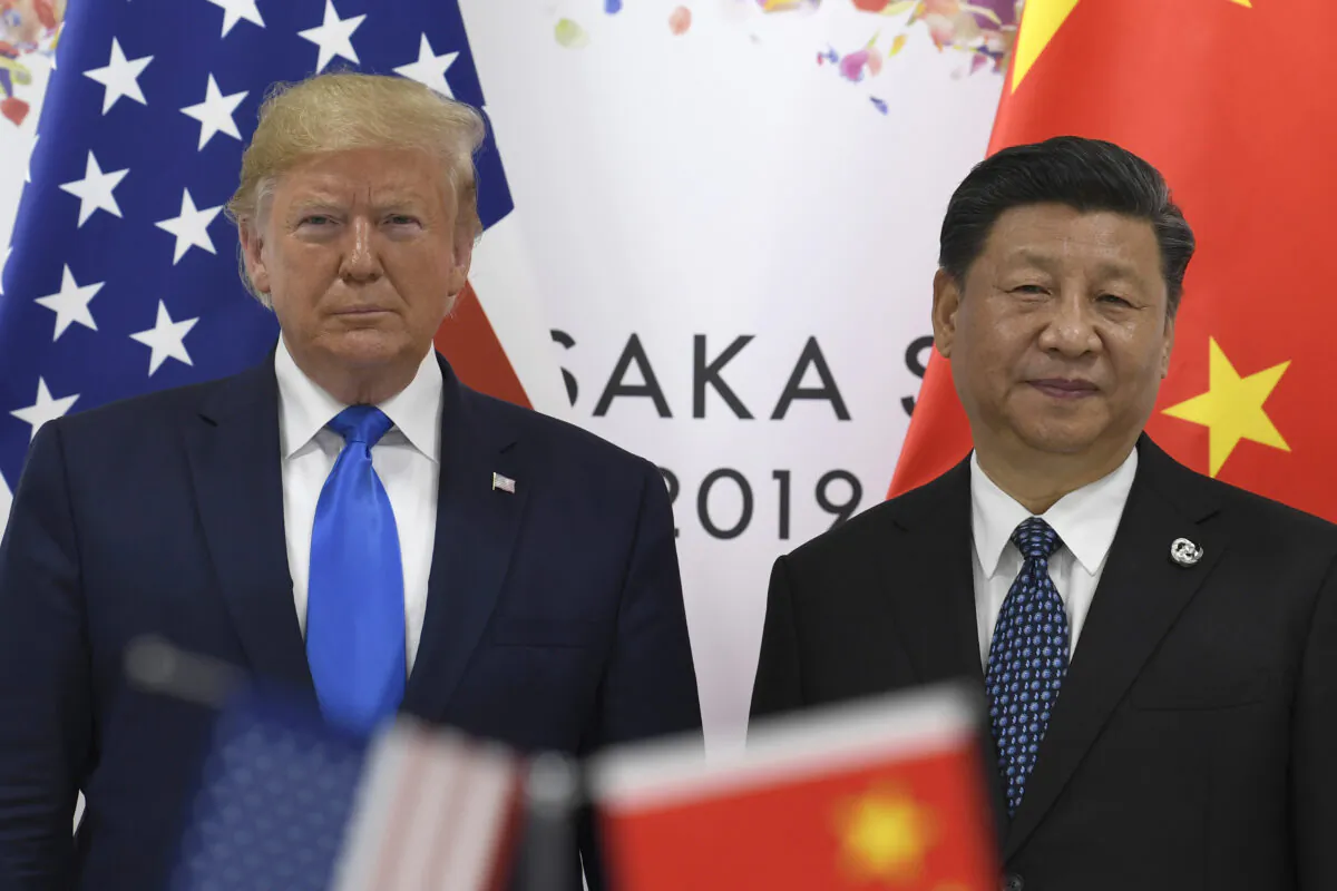 U.S. President Donald Trump poses for a photo with Chinese leader Xi Jinping during a meeting on the sidelines of the G-20 summit in Osaka, Japan, on June 29, 2019. (AP Photo/Susan Walsh)