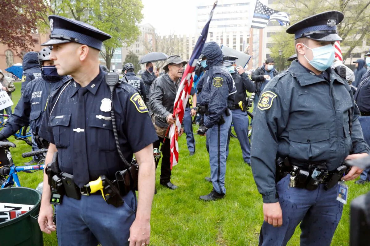 Michigan State Police patrol as demonstrators protest in Lansing, Michigan, on May 14, 2020. (Jeff Kowalsky/AFP via Getty Images)