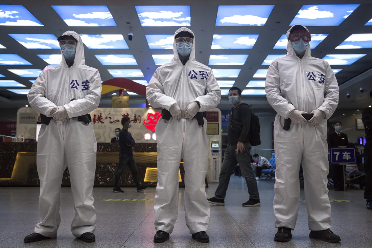 Police stand guard in the a railway station in Wuhan, China, on April 7, 2020. (Getty Images)