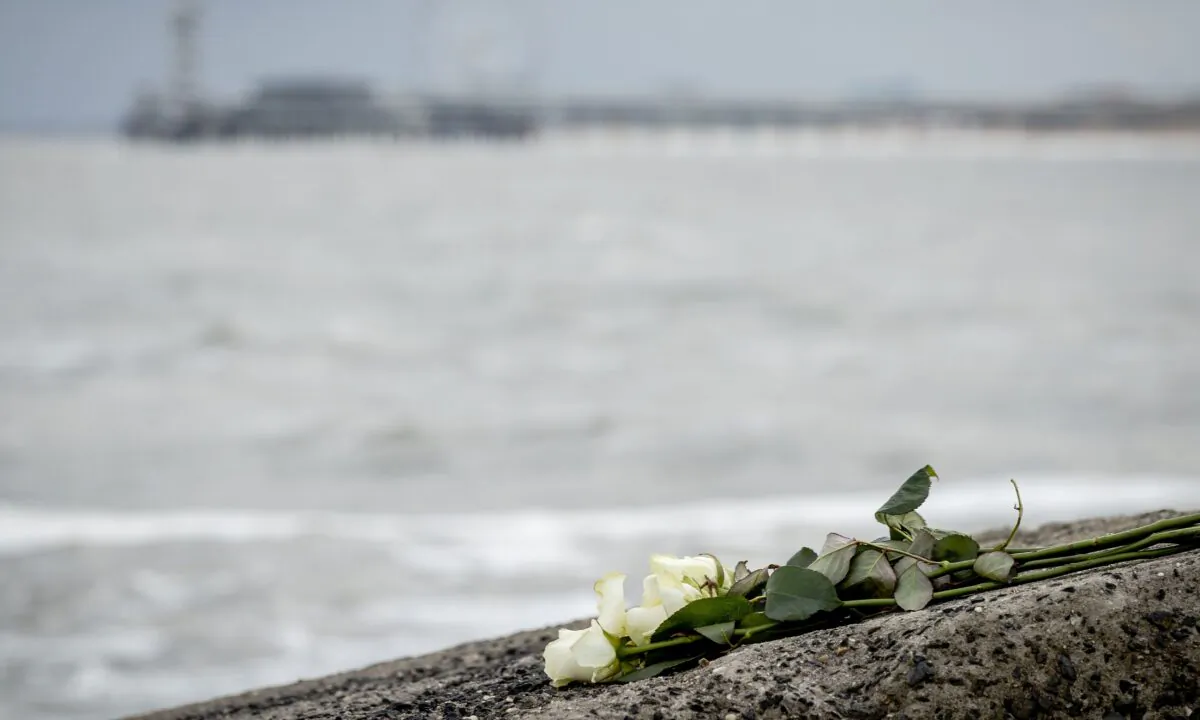Flowers are seen on the Northern Harbor Head in Scheveningen, where five surfers died after getting into difficulty in "avalanche-like" sea foam caused by stormy conditions in the Netherlands on May 13, 2020. (Sem Van Der Wal/ANP/AFP via Getty Images)