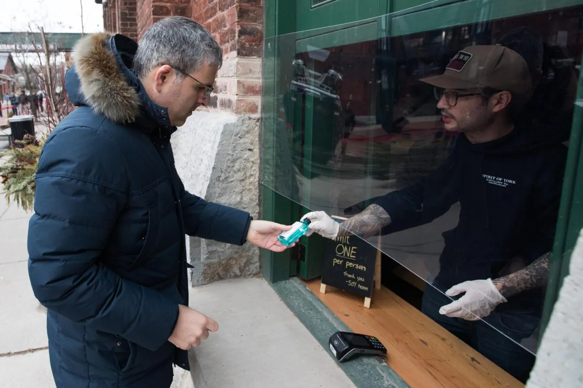 A customer buys a hand sanitizers in Toronto, Ontario, Canada, on March 19, 2020. (Lars Hagberg/AFP via Getty Images)