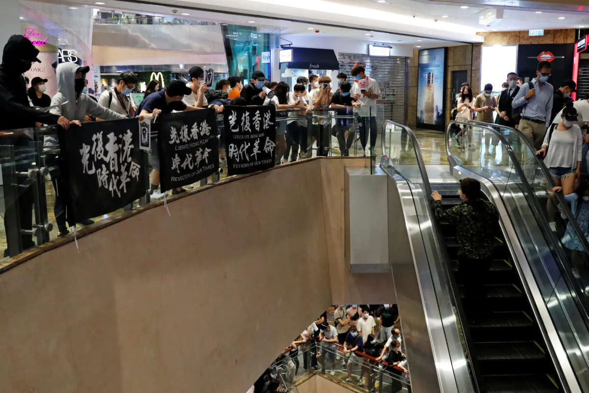 Anti-government protesters stage a rally at a shopping mall to mock Chief Executive Carrie Lam on her birthday at Mong Kok, in Hong Kong, on May 13, 2020. (REUTERS/Tyrone Siu)