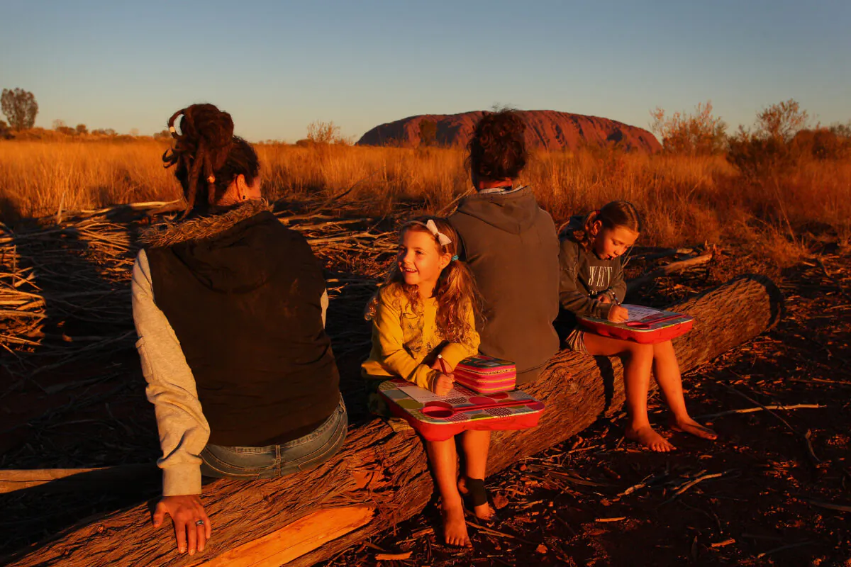 Michelle Pedrotti and Ryan Trott with their daughters take in the sunset view on August 13, 2019 in Uluru, Australia (Lisa Maree Williams/Getty Images)