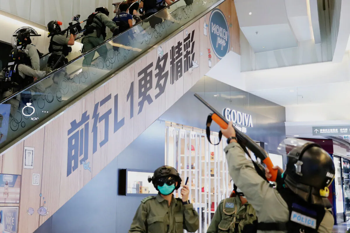 Riot police raise their pepper spray weapons inside a shopping mall as they disperse pro-democracy protesters during a rally, in Hong Kong, China, on May 10, 2020. (Tyrone Siu/Reuters)