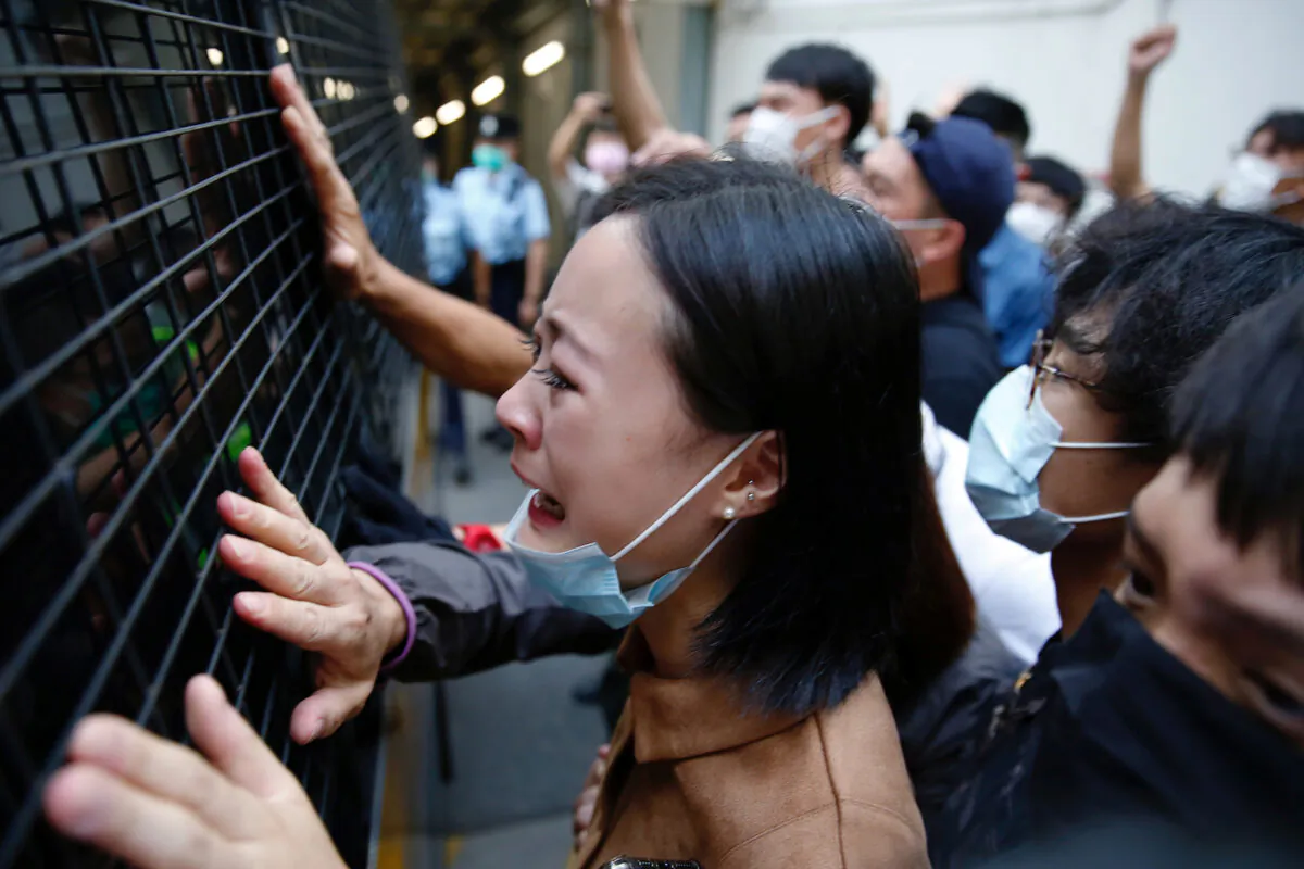 A family member cries and bid farewell to a prison van after pro-democracy protester Sin Ka-ho has been sentenced four years for rioting, in Hong Kong, China, on May 15, 2020. (Tyrone Siu/Reuters)