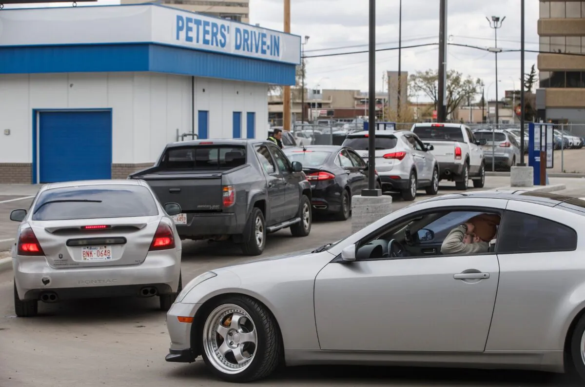 People line up to get food from Peters' Drive-In in Edmonton on May 11, 2020. (Jason Franson/The Canadian Press)