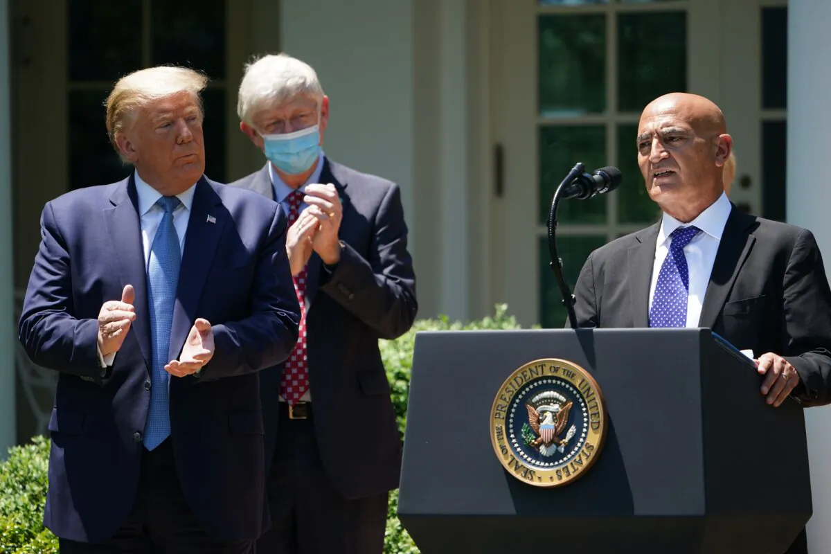 Chief Adviser of Operation Warp Speed Dr. Monecef Slaoui, right, with President Donald Trump, speaks on vaccine development in the Rose Garden of the White House in Washington on May 15, 2020. (Mandel Ngan/AFP via Getty Images)