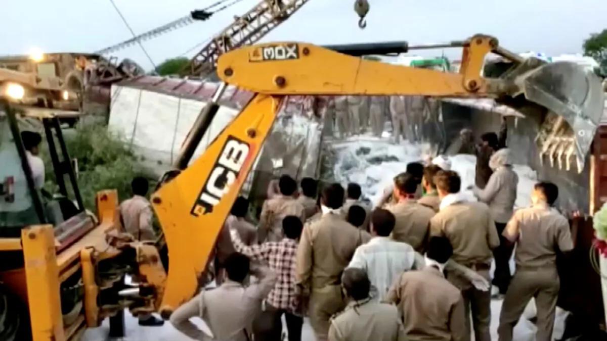 A police rescue team work to lift a truck at the site of an accident where a truck carrying migrant laborers collided with another, killing and injuring several people in Auraiya, Uttar Pradesh, India, May 16, 2020. (Ani/Reuters TV).