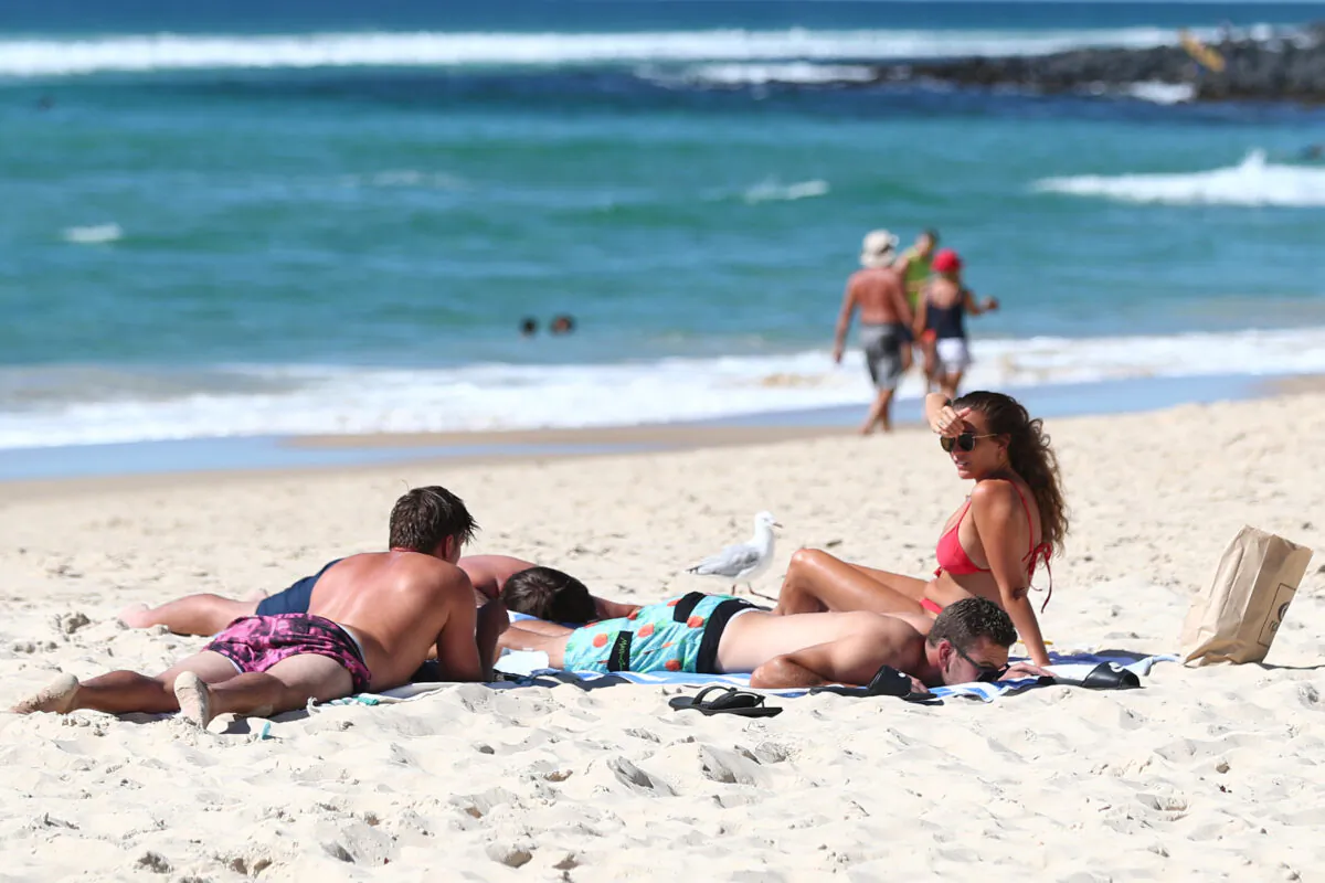 People relax on the beach at Burleigh Heads on May 2, 2020 in Gold Coast, Australia. (Photo by Chris Hyde/Getty Images)