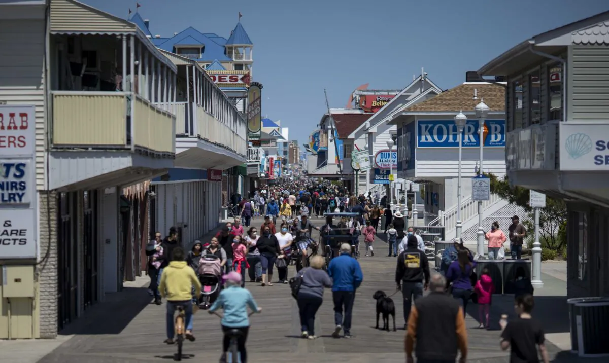 People walk on the boardwalk as the area re-opens from the coronavirus pandemic, in Ocean City, Maryland, on May 10, 2020. (Eric Thayer/Getty Images)