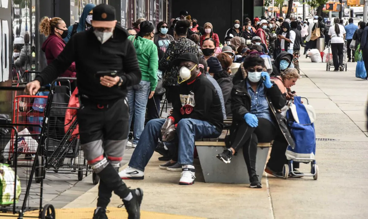 People wait on a long line to receive a food bank donation at the Barclays Center in the Brooklyn borough in New York City on May 15, 2020. (Stephanie Keith/Getty Images)