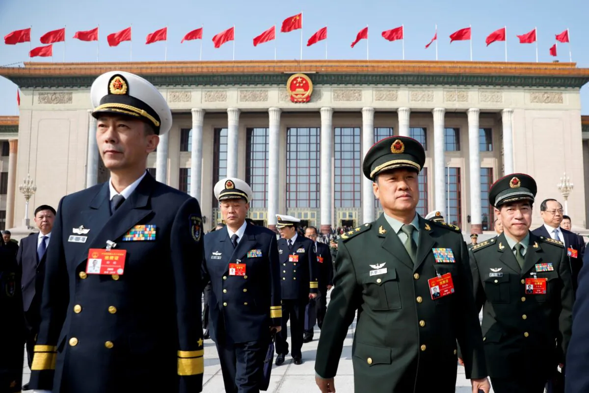 Military delegates leave the Great Hall of the People after a meeting ahead of National People's Congress (NPC), China's annual session of parliament, in Beijing, China, on March 4, 2019. (Aly Song/File Photo/Reuters)