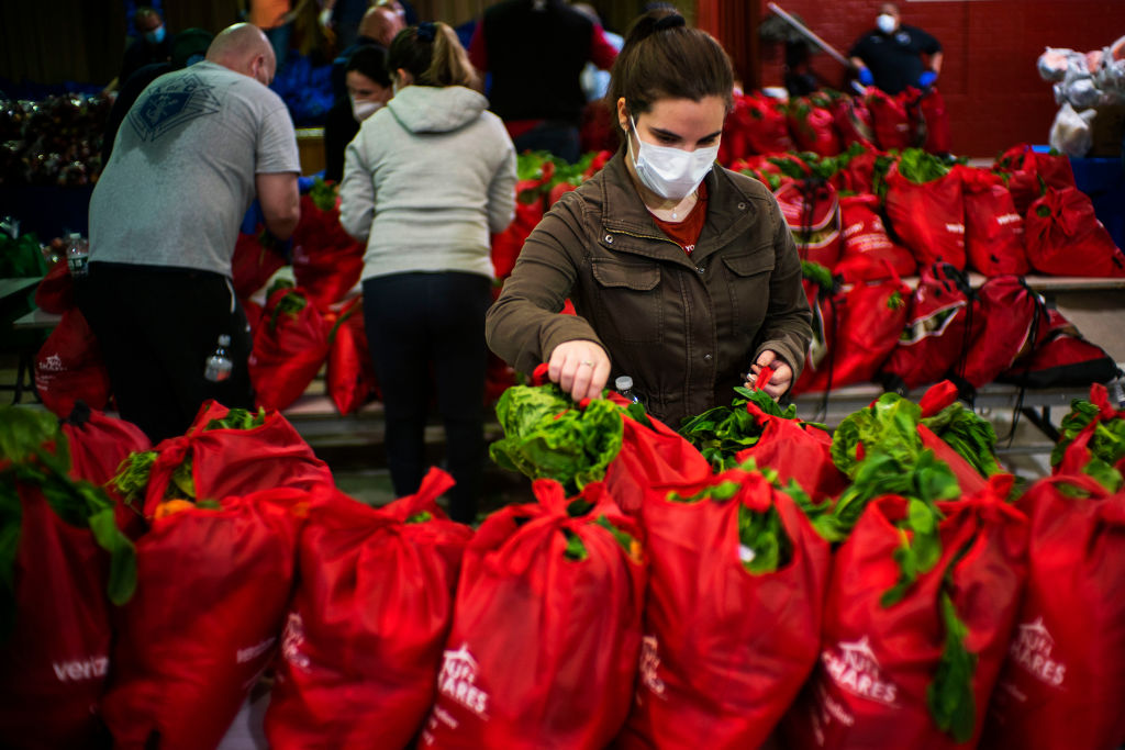 Volunteers organize bags of food during a food distribution at St. Bartholomew's Roman Catholic Church in the Elmhurst neighborhood of Queens on May 15, 2020, in New York City. (Eduardo Munoz Alvarez/Getty Images)