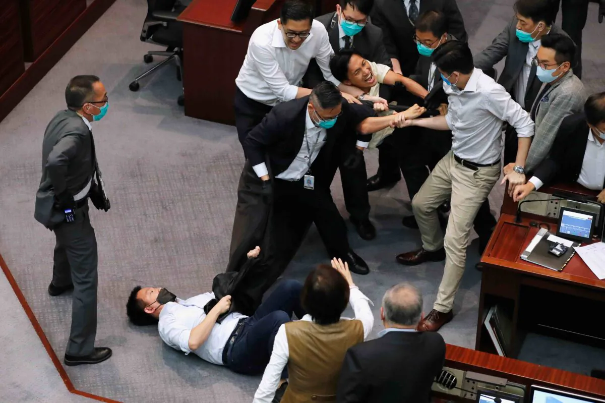 Pan-democratic legislators Chan Chi-chuen and Chu Hoi-dick scuffle with security during Legislative Council’s House Committee meeting, in Hong Kong, China, on May 18, 2020. (Tyrone Siu/Reuters)