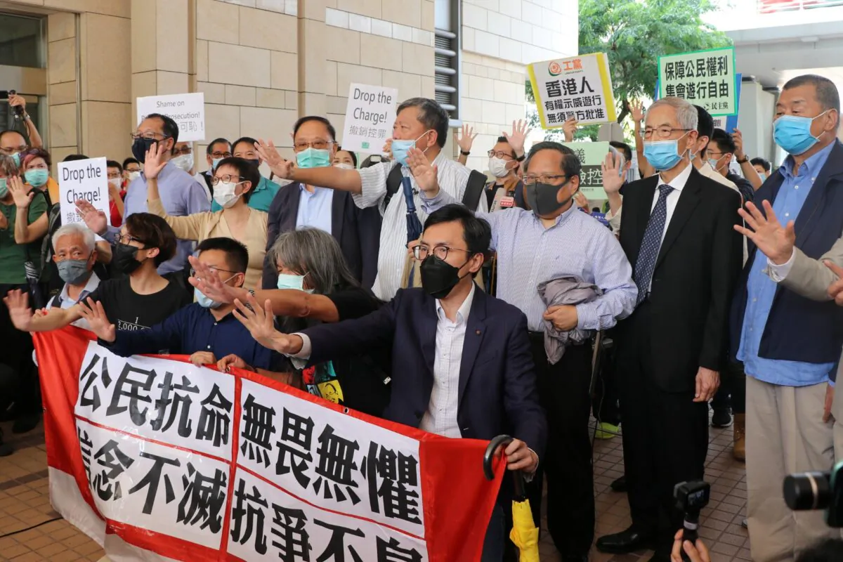 Pro-democracy activists chant slogans outside the West Kowloon Magistrates Court, in Hong Kong, China, on May 18, 2020. (Jessie Pang/Reuters)