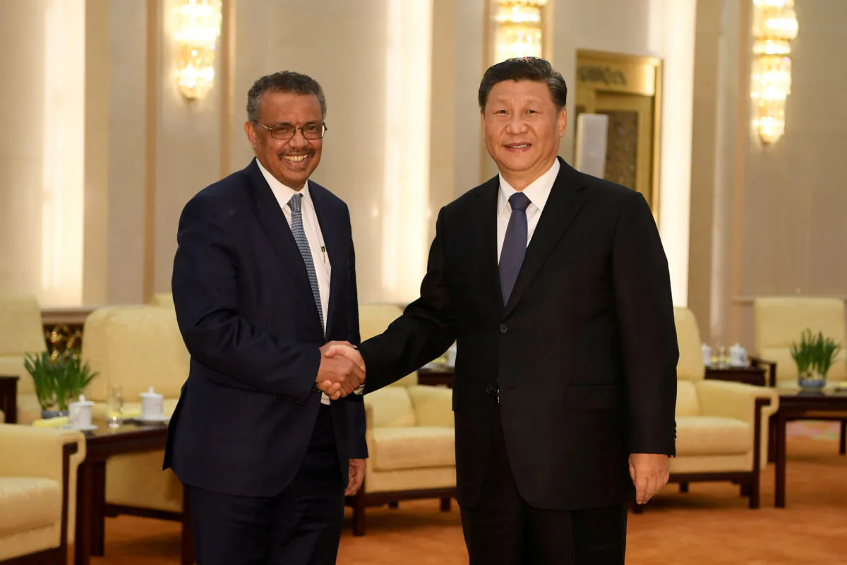 Tedros Adhanom, director general of the World Health Organization, shakes hands with Chinese leader Xi Jinping before a meeting at the Great Hall of the People in Beijing, China, Jan. 28, 2020. (Naohiko Hatta/Reuters)