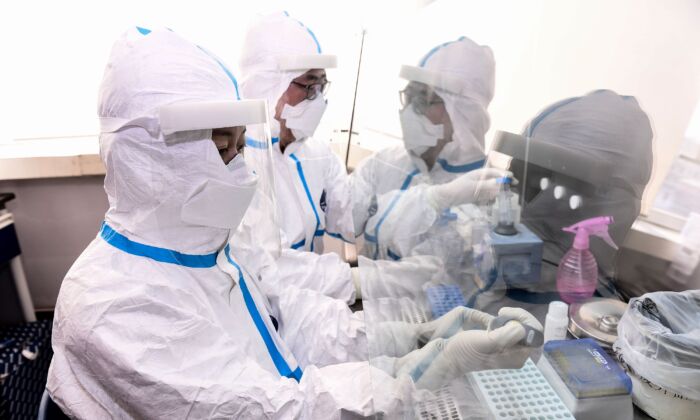 Laboratory technicians work on testing samples from people to be tested for the CCP virus at a laboratory in Shenyang, China, on Feb. 12, 2020. (STR/AFP via Getty Images)