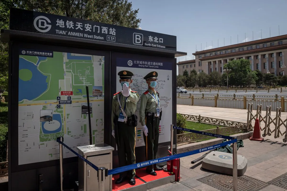 Paramilitary police officers guard near the Great Hall of the People (back) in Beijing on May 18, 2020. (NICOLAS ASFOURI/AFP via Getty Images)