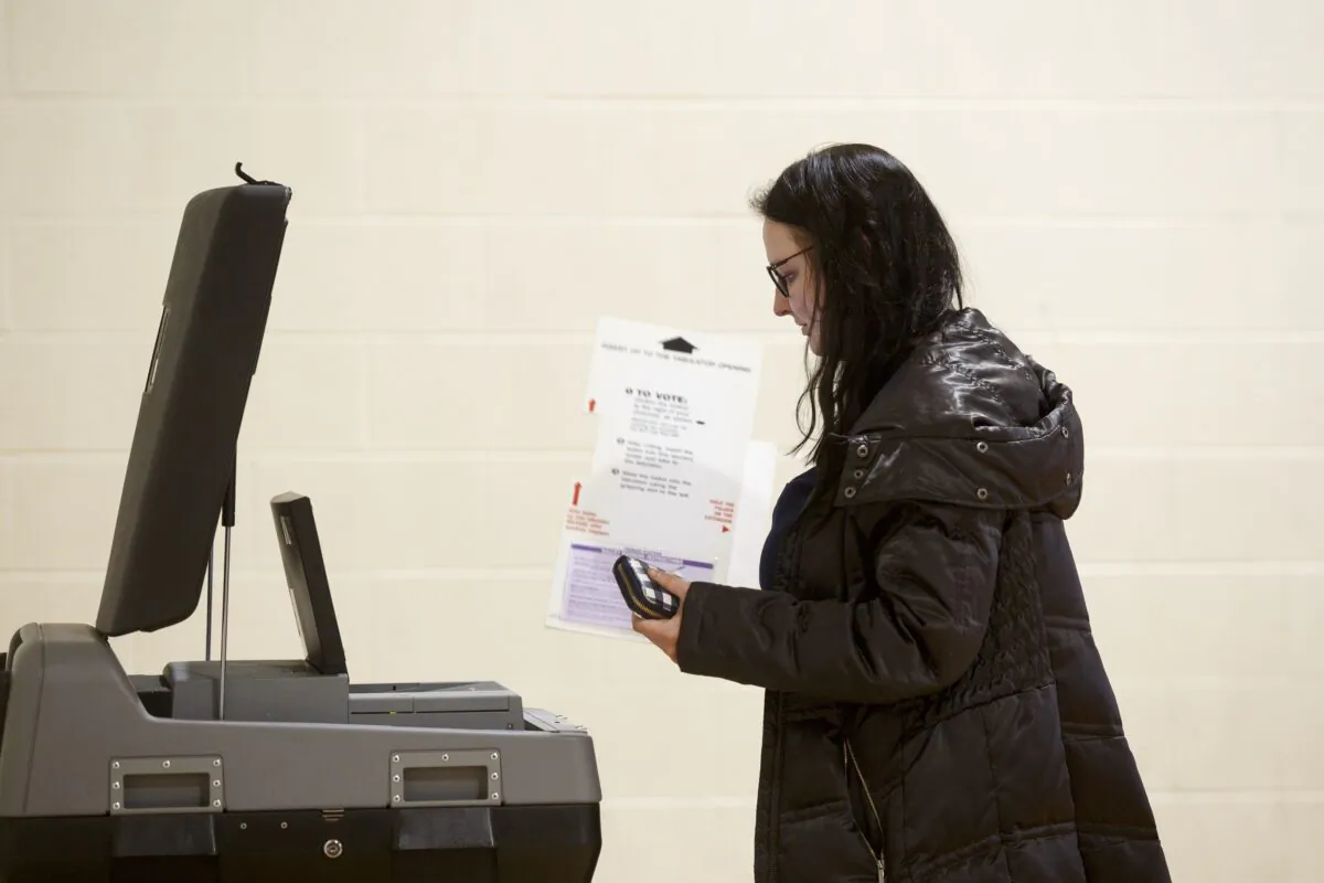 A woman holds a ballot at a polling place at Cromie Elementary School in Warren, Mich. on March 10, 2020. (Elaine Cromie/Getty Images)