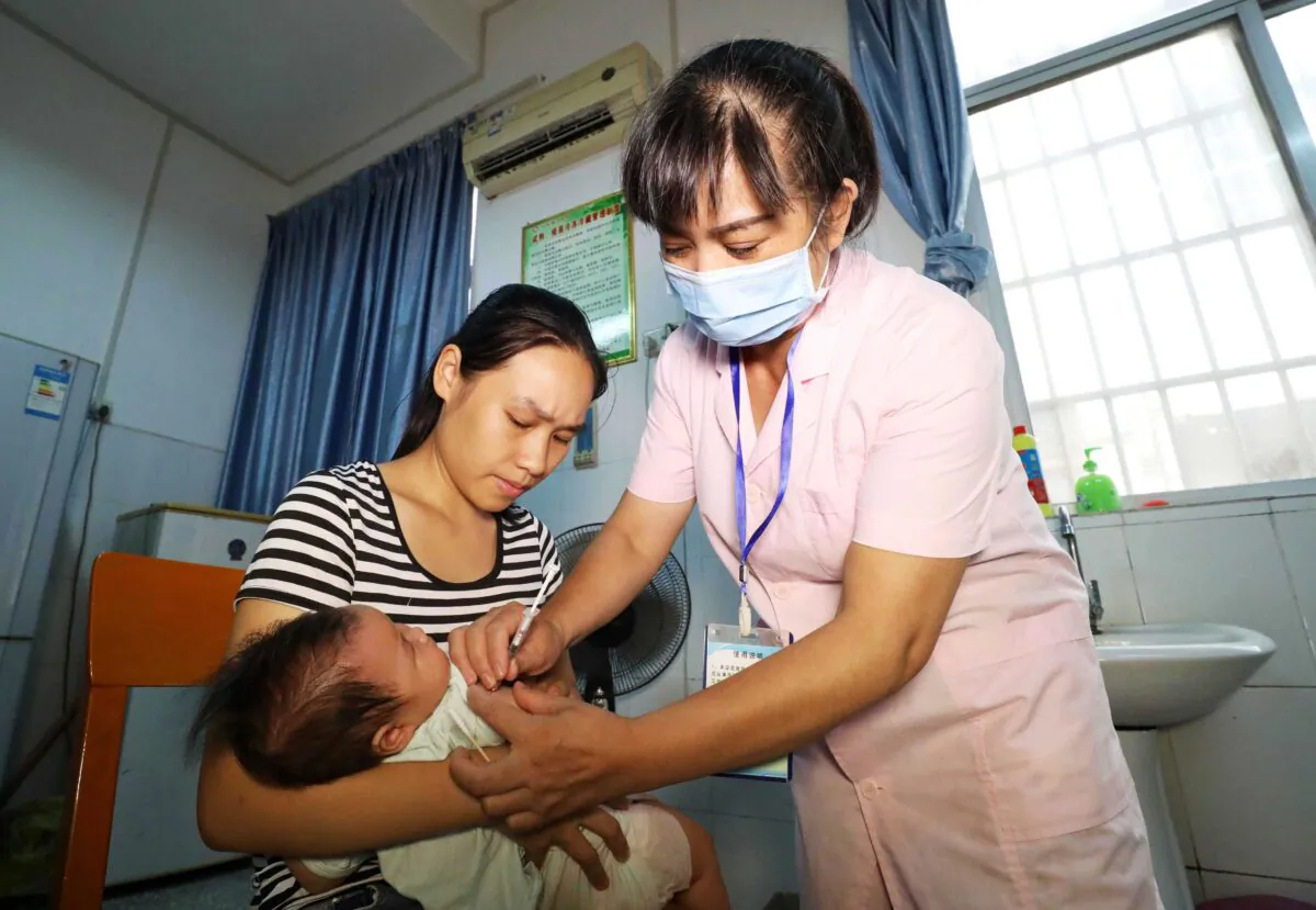 A child receives a vaccination shot at a hospital in Rongan in China's southern Guangxi region on July 23, 2018. That year, a scandal rocked China after a Chinese company was found to have shipped more than 250,000 doses of a faulty DTaP vaccine, affecting more than 200,000 children. (AFP via Getty Images)