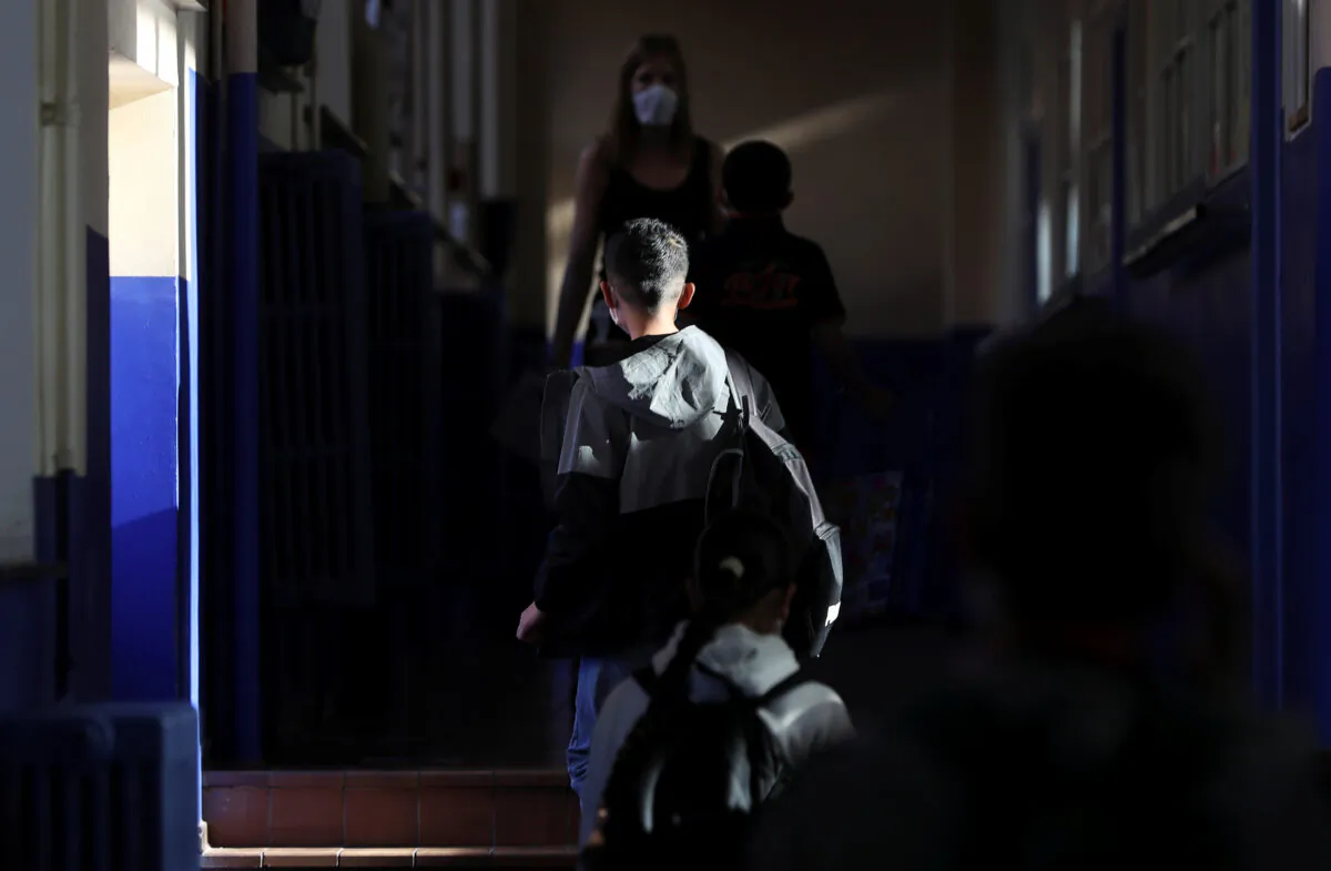 A student walks inside a francophone primary school during its reopening in Jumet, as a small part of Belgian children head back to their schools with new rules and social distancing measures, during the outbreak of the CCP virus in Jumet, Belgium, on May 18, 2020. (Yves Herman/Reuters)
