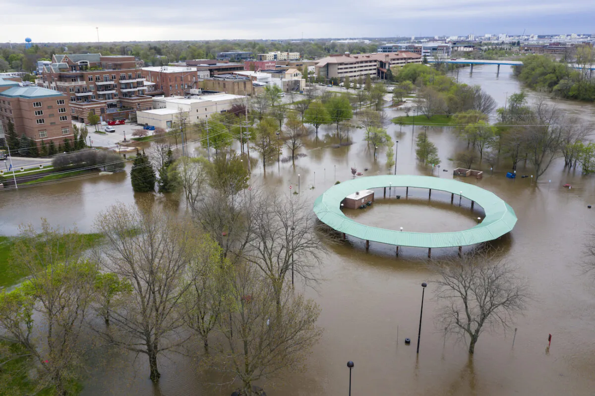Water floods the Midland Area Farmers Market and the tridge along the Tittabawassee River in Midland on May 19, 2020. (Kaytie Boomer/MLive.com via AP)