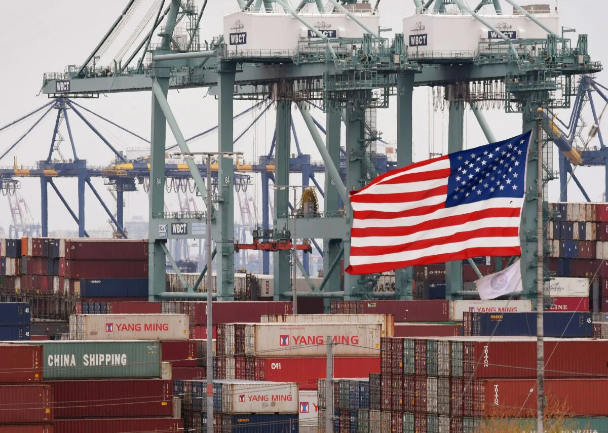 Chinese shipping containers are stored beside a US flag after they were unloaded at the Port of Los Angeles in Long Beach, Calif., on May 14, 2019. (MARK RALSTON/AFP via Getty Images)