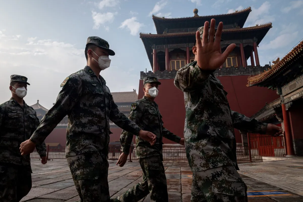 China's People's Liberation Army soldiers march next to the entrance to the Forbidden City during the opening ceremony a political meeting in Beijing on May 21, 2020. (NICOLAS ASFOURI/AFP via Getty Images)