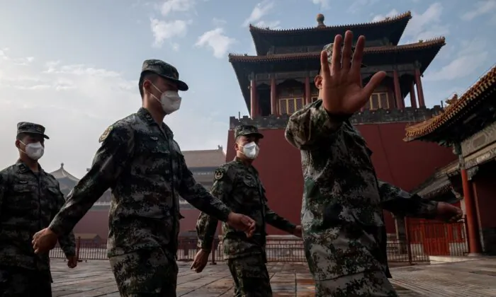 China's People's Liberation Army soldiers march next to the entrance to the Forbidden City during the opening ceremony a political meeting in Beijing on May 21, 2020. (NICOLAS ASFOURI/AFP via Getty Images)