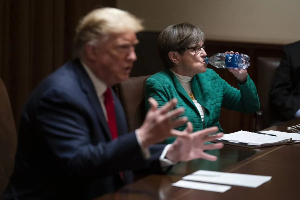 Kansas Gov. Laura Kelly listens as President Donald Trump speaks during a meeting in the Cabinet Room of the White House on May 20, 2020, in Washington. (Evan Vucci/AP Photo)