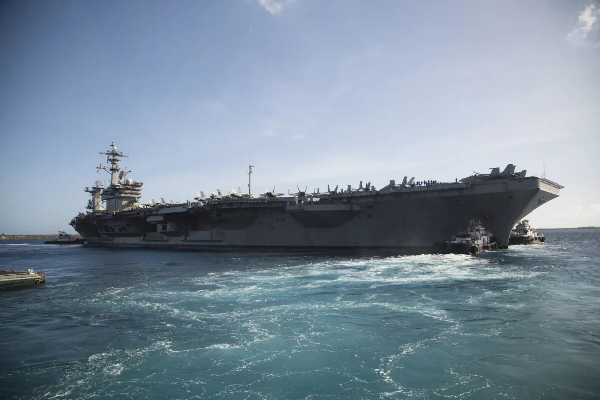 The aircraft carrier USS Theodore Roosevelt (CVN 71) departs Apra Harbor following an extended visit to Guam in the midst of the COVID-19 global pandemic, in an undated file photo. (U.S. Marine Corps photo by Staff Sgt. Jordan E. Gilbert)