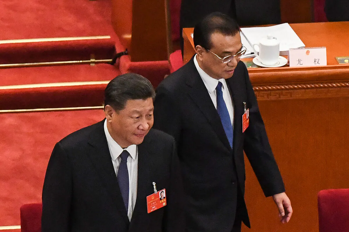 Chinese leader Xi Jinping (L) and Premier Li Keqiang (R) arrive for the opening session of the National People's Congress (NPC) at the Great Hall of the People in Beijing on May 22, 2020. (Leo Ramirez/AFP via Getty Images)