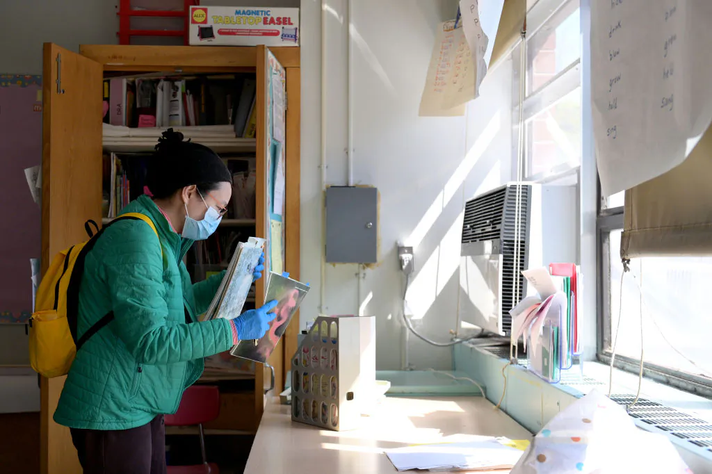 A teacher collects supplies needed to continue remote teaching through the end of the school year at P.S. 124 Yung Wing School in New York on May 14, 2020. (Michael Loccisano/Getty Images)