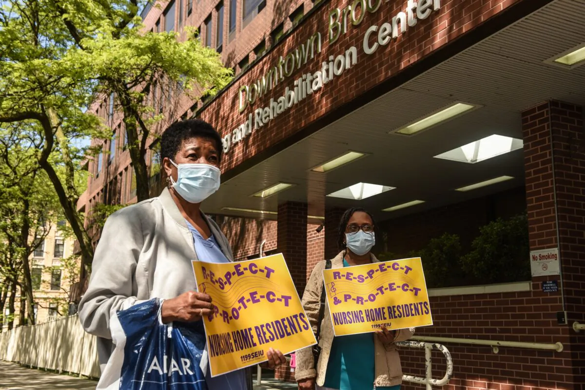 Nursing home workers hold a vigil outside of the Downtown Brooklyn Nursing and Rehabilitation Center in New York on May 21, 2020. (Stephanie Keith/Getty Images)