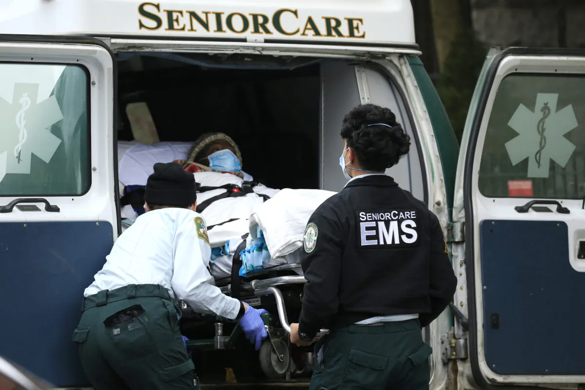 Emergency Medical Service workers unload a patient out of their ambulance at the Cobble Hill Health Center in the Cobble Hill neighborhood of the Brooklyn borough of New York City on April 18, 2020. (Justin Heiman/Getty Images)