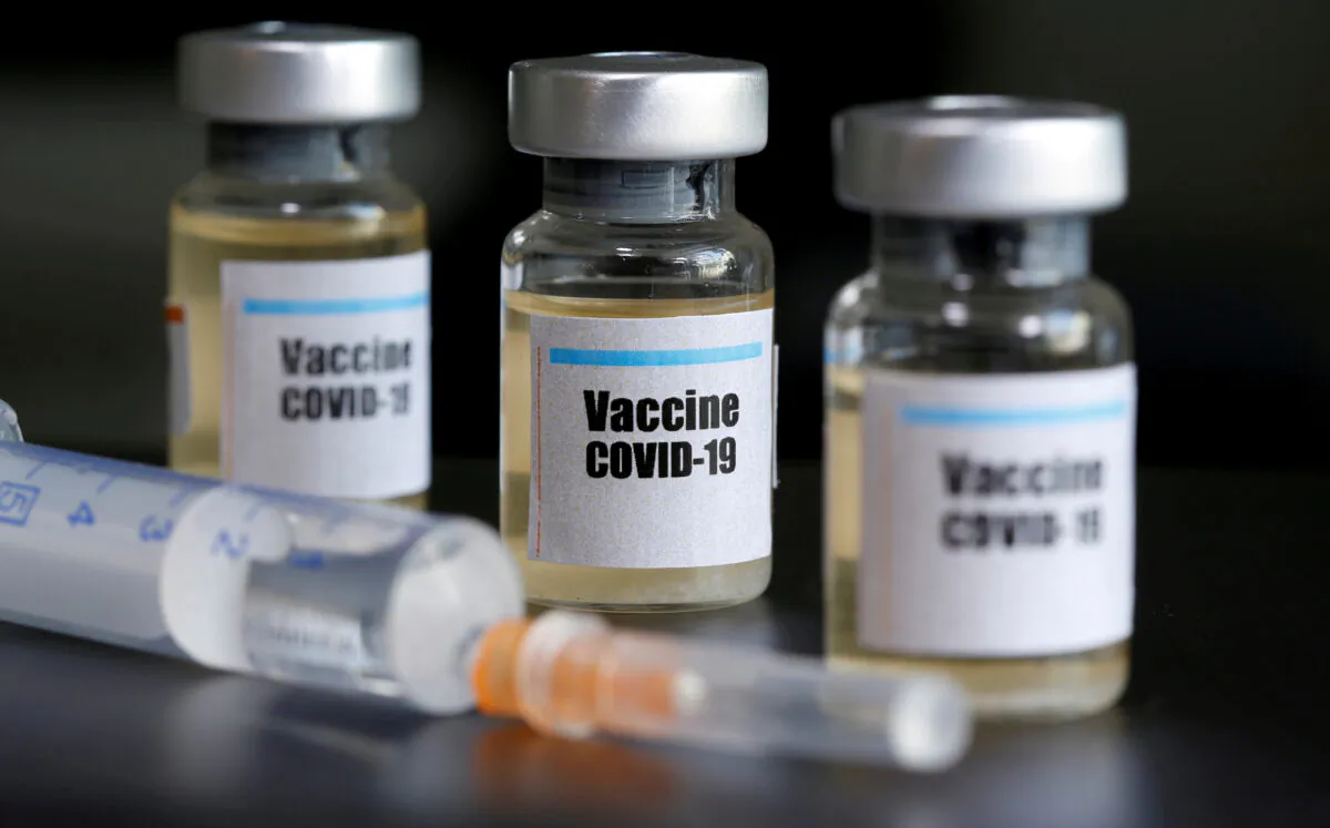 Small bottles labeled with a "Vaccine COVID-19" sticker and a medical syringe are seen in this illustration taken taken April 10, 2020. (Dado Ruvic/Illustration/Reuters)