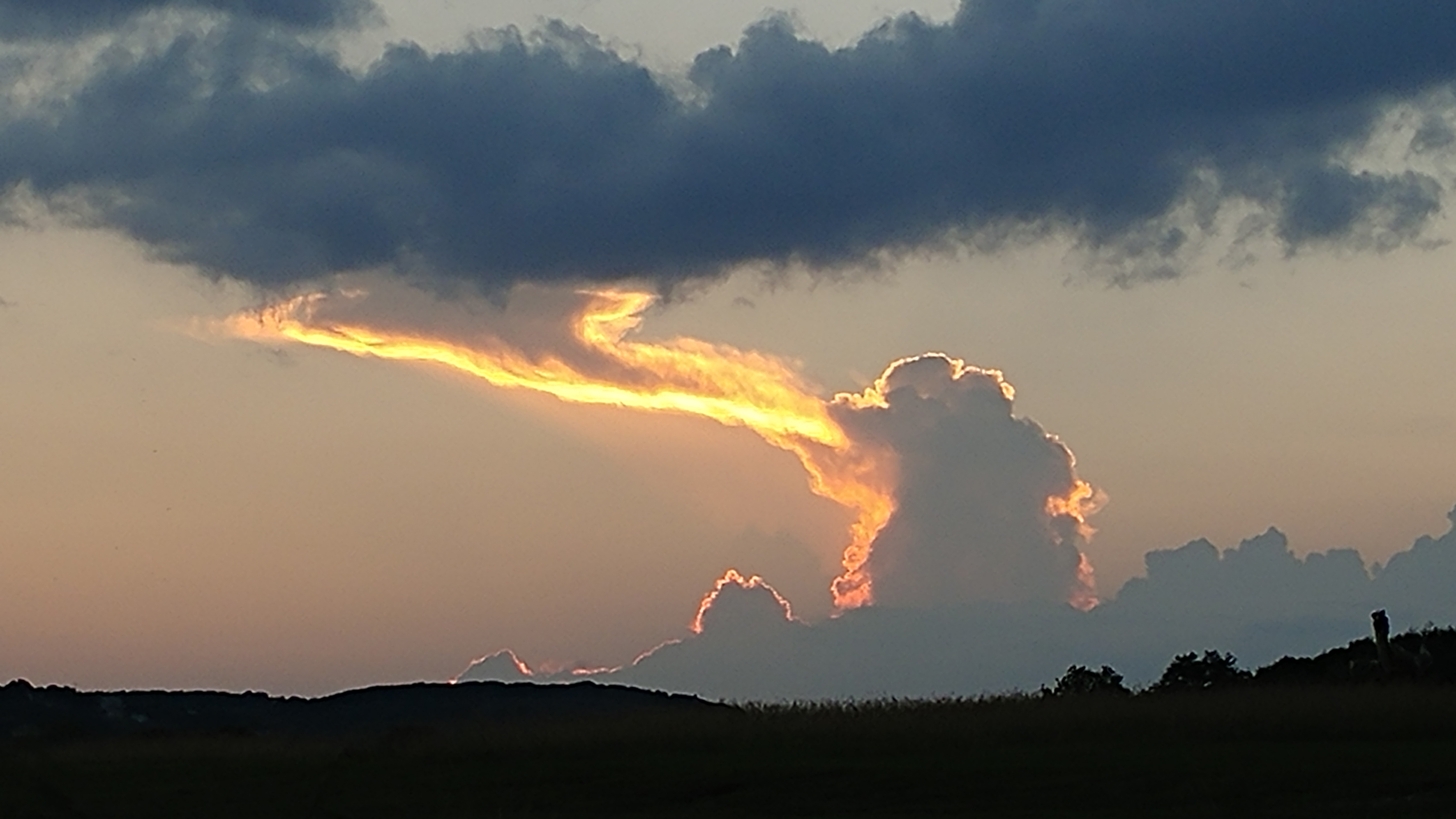 Unusual Cloud Looks Like a Huge ‘Dragon’ Breathing Fire Into the Sky